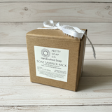 Brown cardboard soap sampler pack with a label on a wooden surface