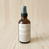 Vanilla Dreams spray bottle from Pretty Soap Co. on a wooden surface